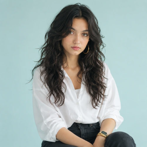 Curly long wolf cut with soft layered hair, face-framing texture, and natural volume for a trendy women's hairstyle.