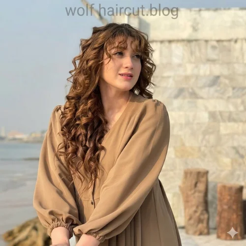 "Modern wolf haircut for curly hair with long layered curls, wispy bangs, soft texture, and voluminous face-framing movement."