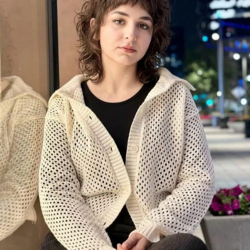 "Shaggy wolf haircut with choppy textured layers, soft wispy bangs, and feathered ends creating effortless volume and movement."