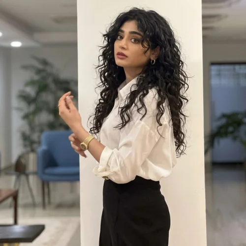 "Waterfall wolf haircut for curly hair with cascading long layers, defined curls, face-framing pieces, and voluminous texture."