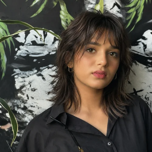 Short wolf cut with wispy bangs and textured layers for women, soft shag hairstyle inspiration .